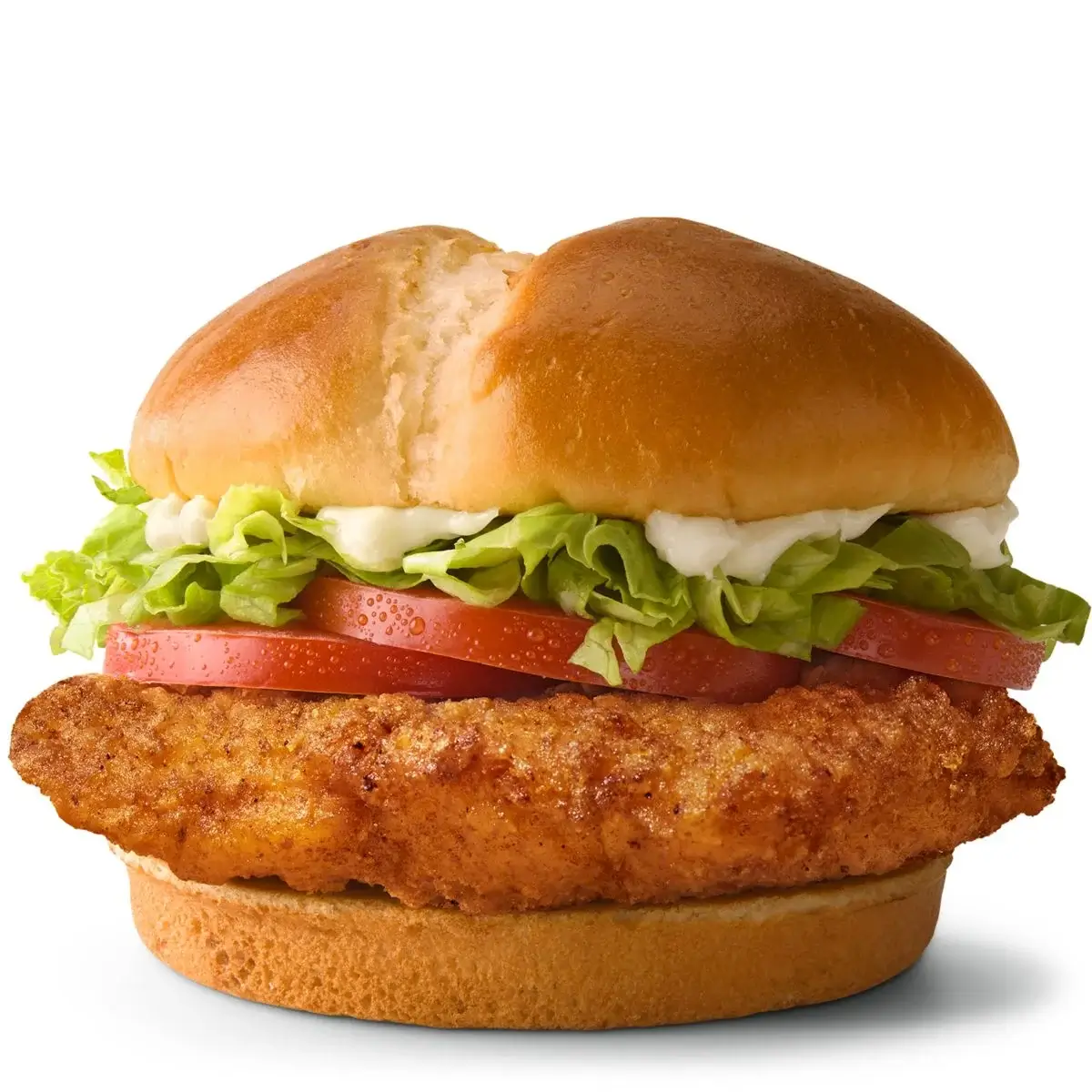 Crispy chicken sandwich with lettuce, tomato, and mayo on a bun.