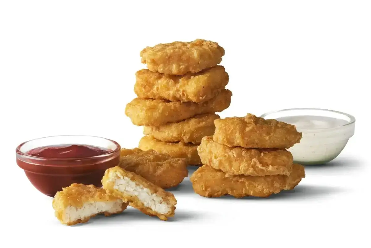 Golden, crispy chicken nuggets in a small box.